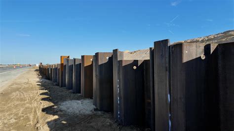 Crews Continue Constructing Sheet Metal Barrier Along Route One